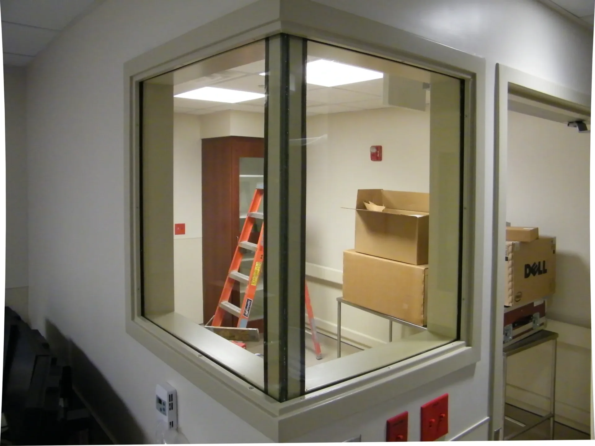 Room with boxes and a ladder inside.