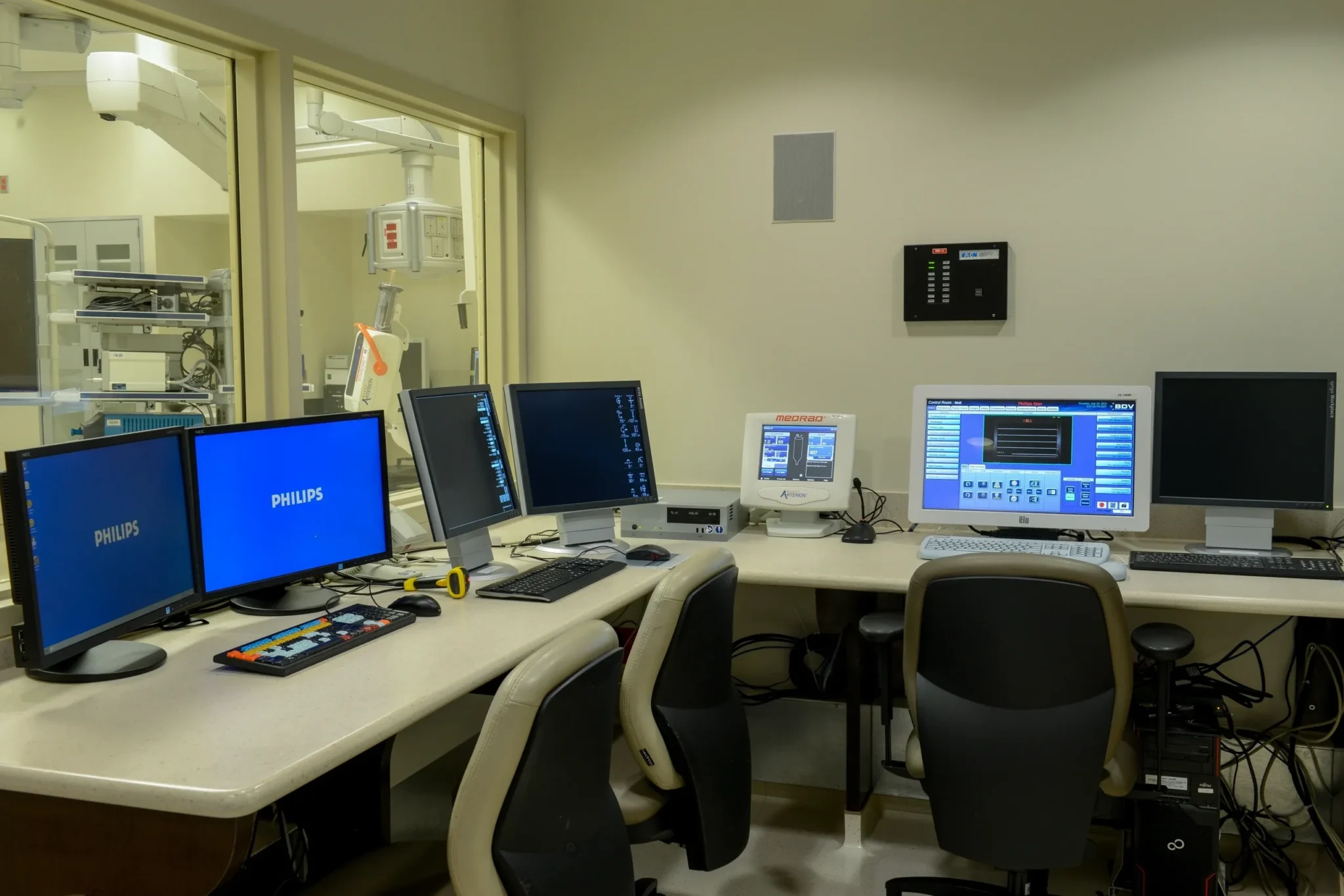 Hospital control room with multiple computer monitors.