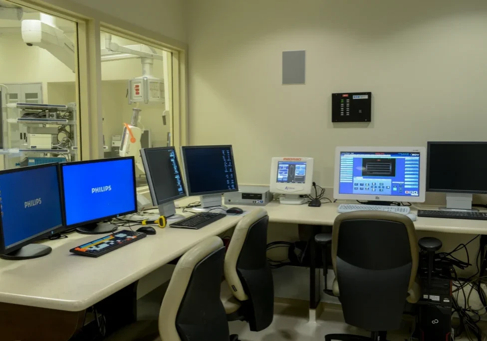 Hospital control room with multiple computer monitors.